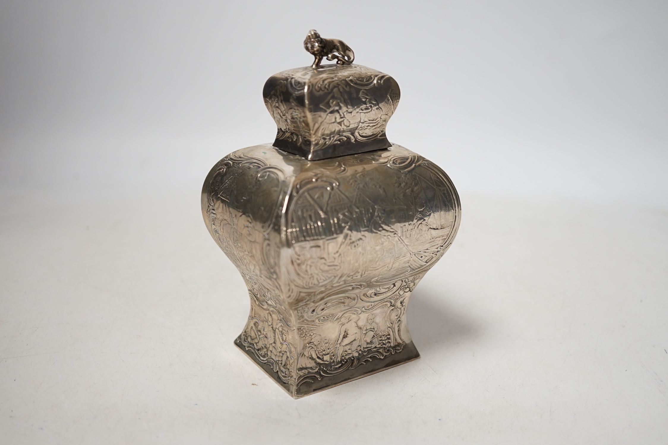 A late 19th century Hanau embossed white metal bombe shaped tea caddy, with lion en passant finial, 13.8cm, 5.5 oz.